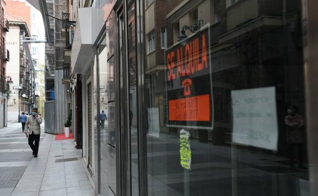 Ciudadanos paseando frente a comercios cerrados en Valladolid./R. Jiménez