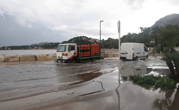 Vehículos por una zona inundada de Dénia, junto a la Marineta Cassiana. 